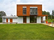 Na sv�tle omítnuté p�ízemí nasadili architekti p�esahující "lo�nicové" t�leso odli�ené mod�ínovým oblo�ením mo�ené na barvu ko�aku