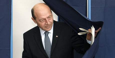 Odstupující rumunský prezident Traian Basescu vychází z volební místnosti (22.