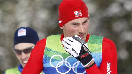 Norský běžec Petter Northug po doběhu olympijské štafety, v pozadí Martin Koukal.