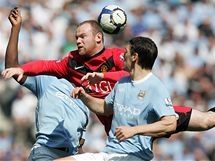 HLAVIKOV SOUBOJ. tonk Wayne Rooney z Manchesteru United (v ervenm) se pere v hlavikovm souboji o m s Garethem Barrym z Manchesteru City.