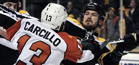 ZUIVEC. Daniel Carcillo z Philadelphie útoí na Andrew Ference z Bostonu.