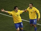 UP A JDEME SLAVIT. Stelec Fabiano a jeho nahráva Kaká utíkají oslavovat druhý gól Brazilc do sít Chile.