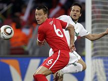 Anglický stoper Terry zasahuje před slovinským protihráčem