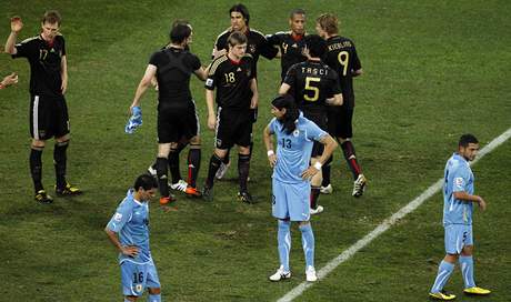 Zatímco nmetí fotbalisté se radují z bronzových medailí, uruguaytí fotbalisté jen zklaman postávají na trávníku.