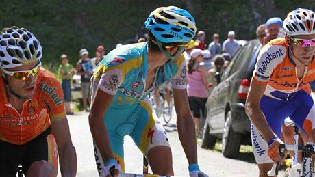 Nový lídr Tour de France Alberto Contador se ohlíí na Andyho Schlecka, který se pod zatákou snaí nasadit spadlý etz.