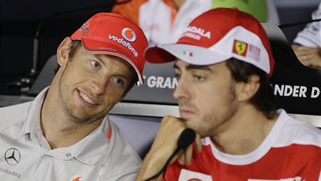 ALE CO BLBNE... Jenson Button sleduje soupee Fernanda Alonsa pi tiskové konferenci v italské Monze ped zaátkem Velké ceny. 