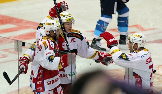 Hokejisté Slavie se radují z gólu Michala Vondrky (vlevo)
