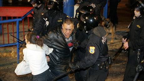 KONFLIKT. ena odtahuje mue od policist, kteí zasahovali ped zápasem Baník Ostrava - Plze proti nepístojnostem fanouk ped stadionem.