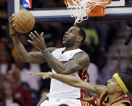 LeBron James (v blm) z Miami Heat zakonuje pes atak Jamaria Moona z Clevelandu Cavaliers