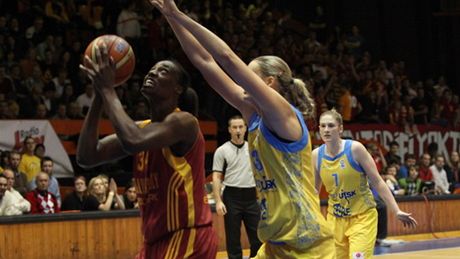 Sylvia Fowlesová (v �erveném) z Galatasaray Istanbul zakon�uje p�es obranu Petry Kulichové z USK Praha.