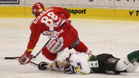 NA ZEMI. Tomá� Rohan z Karlových Var� se pokou�í vle�e vypíchnout puk slávistovi Jakubu Sklená�ovi.