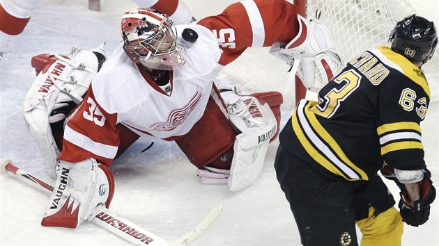 Jimmy Howard z Detroitu chytá stelu Brada Marchanda z Bostonu. 