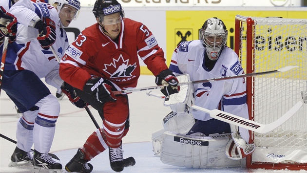 ŽENE SE ZA PUKEM. Kanadský hokejista Jeff Skinner se natahuje po odraženém puku, který klouže vedle francouzské branky. Na zádech má však Nicolase Besche a u své levé tyčky je pozorný i Cristobal Huet. 