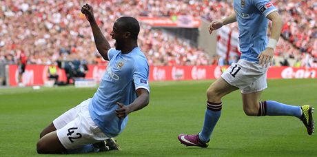 RADOST NA KOLENOU. Yaya Touré z Manchesteru City se raduje, práv vstelil jedinou branku ve finále FA Cupu. Slavit pibíhá i Adam Johnson.