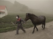 Farmka z Horgslandu vede svho kon mraky sopenho popela (21. kvtna 2011)