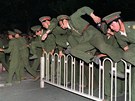 íntí vojáci peskakují zátarasy a vyráí proti demonstrantm na Tchien-an-men...