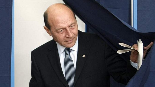 Odstupující rumunský prezident Traian Basescu vychází z volební místnosti (22.