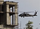 Helikoptéra NATO krouí kolem rozestavné výkové budovy, ve které se ukrývají