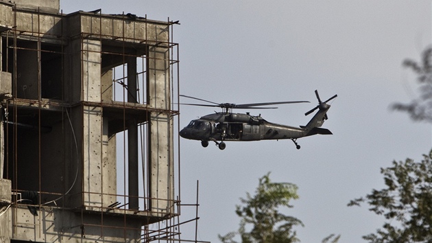 Helikoptéra NATO krouí kolem rozestavné výkové budovy, ve které se ukrývají