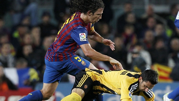 NA ZEM! Carles Puyol, stoper Barcelony (vlevo), povalil v utkání se Zaragozou