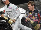 Michael Schumacher (vpravo) a Sebastian Vettel oslavují svj triumf mezi týmy