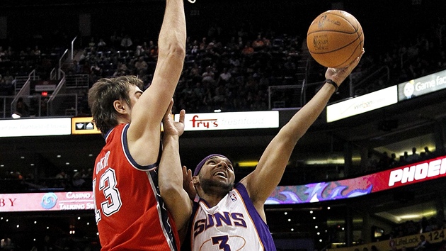 Jared Dudley (vpravo) z Phoenixu stílí pes Mehmeta Okura z New Jersey.