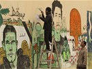 Egypan kreslí nedaleko námstí Tahrír v Káhie graffiti s oblieji lidí, kteí