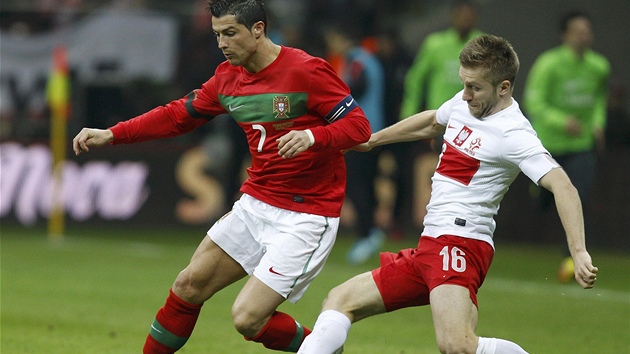 PORTUGALSKÉ KLI�KY. Cristiano Ronaldo (v �erveném) obchází polského