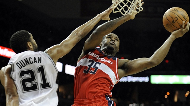 Trevor Booker z Washingtonu se vyhýbá bloku Tima Duncana ze San Antonia.