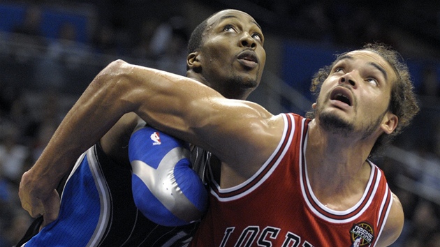 Joakim Noah z Chicaga bere p�i doskoku na záda Dwighta Howarda z Orlanda.