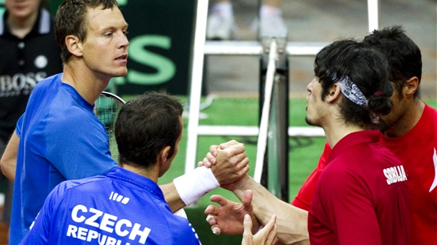 Tom Berdych a Radek tpnek si po vtzn tyhe podvaj ruce se srbskmi soupei Iljou Bozoljacem (ble) a Nenadem Zimonjiem.