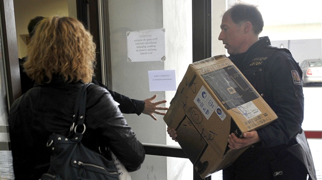 Policist pinej krabici s dkazy do sdla tvaru pro odhalovn organizovanho zloinu (OOZ) v Dldn ulici v Praze (15. kvtna 2012)