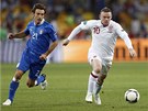 ÚPRK K BRANCE. Anglický útoník Wayne Rooney se ítí do útoku, stíhá ho Ital