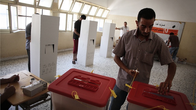 Jeden z voli práv vhazuje lístek do urny v Tripolisu (7. ervence 2012)