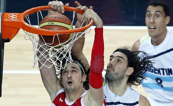 Ruský basketbalista Alexej ved (vlevo) skóruje, Argentinec Luis Scola se mu v