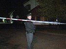 Policista hlídá píjezdovou cestu k restauraci v Ládví, v ní bylo nalezeno