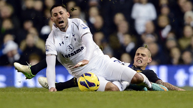KOSA. Clint Dempsey z Tottenhamu (v blm) pad po tvrdm skluzu liverpoolskho stopera Martina krtela.
