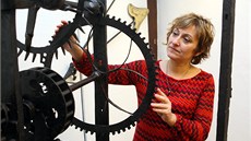 Muzejnice Ingrid Kotenová ukazuje jeden z vystavených strojů na měření času. 