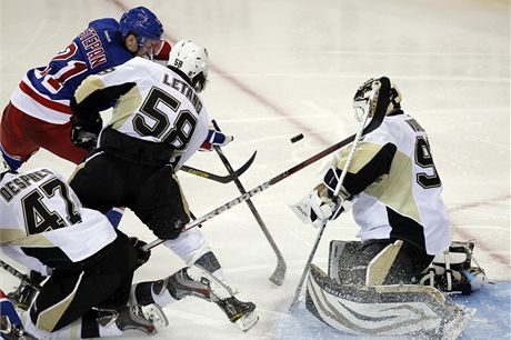 Tomá Vokoun z Pittsburghu zasahuje ped Derekem Stepanem z NY Rangers. Tomu