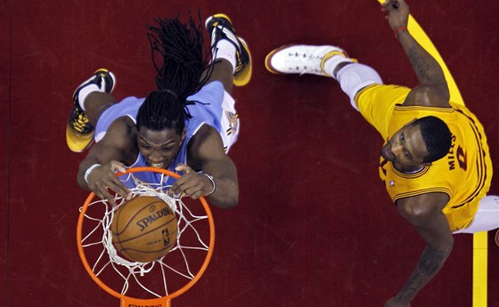 Kenneth Faried (vlevo) z Denveru dává ko v zápase s Clevelandem. Vpravo