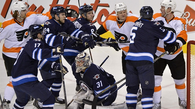 Branká Winnipegu Ondej Pavelec má puk ve své moci, nad ním se pouchují jeho