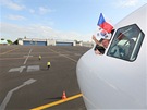 Z okénka pilotní kabiny mává kapitán letadla Ivan Janouek.