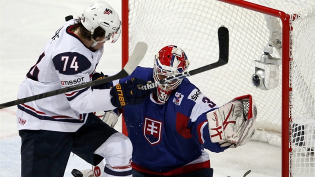 Slovensk brank Rastislav Staa m zakryt vhled, clon ped nm Amerian T.J. Oshie. 