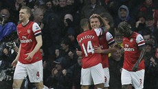 Theo Walcott z Arsenalu objímá úspného stelce Lukase Podolského.
