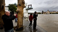 Lidé sledují stoupající Vltavu u Musea Kampa v Praze. Muzeum je kvli povodové