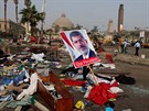 Egypan s plakátem sesazeného prezidenta Muhammada Mursího v troskách tábora...