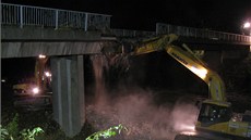 Dálniní nadjezdy stavební firmy pi modernizace D1 demolovaly u nkolikrát. Práce vdy probíhaly stejn. Most rozebrala tká technika, zbytek spadl na pískový poltá na dálnici a su odvezla nákladní auta. Snímek je z bourání mostu u Velké Bítee.