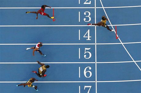 ZÁVOD ATLET. Jamajan Usain Bolt pebíhá jako první cílovou áru pi...