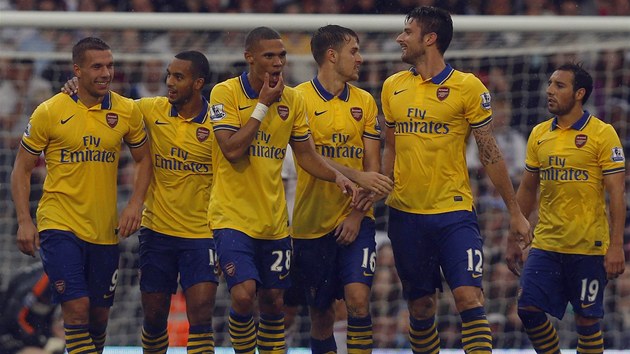 Fotbalist Arsenalu oslavuj gl Lukase Podolskho (vlevo).