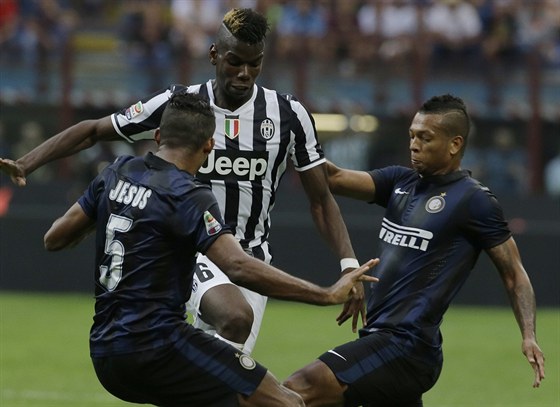 ZKÍÍME TI CESTU. Záloníka Juventusu Turín Paula Pogbu (uprosted) brání hned...